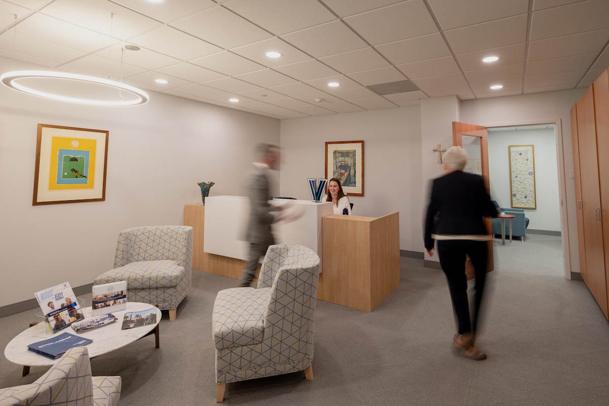 collections-page Blurred individuals walking through an office