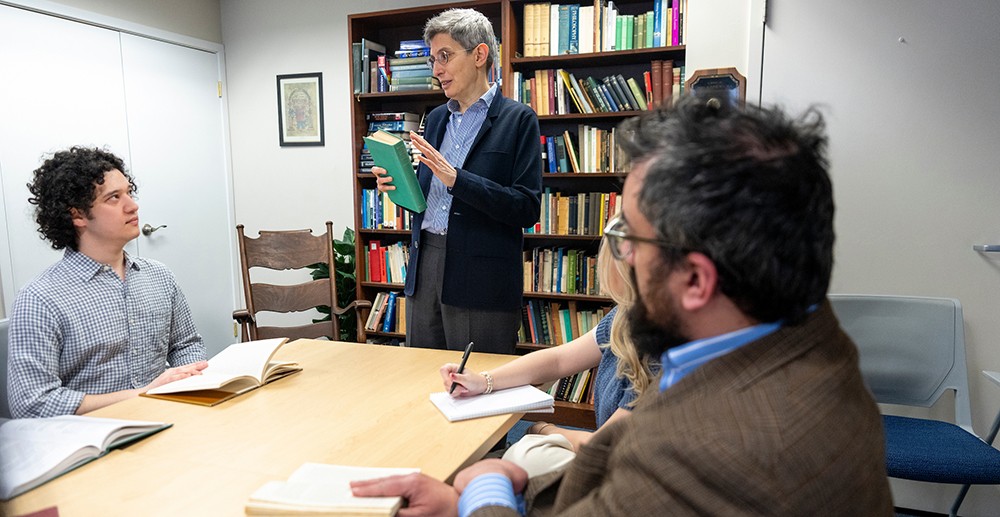 faculty and graduate students meeting around a table