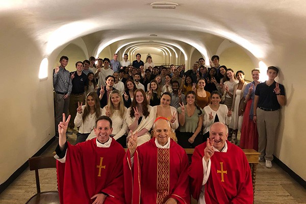 Students attend mass in Rome. The Rev. Kevin M. DePrinzio, OSA, PhD, Vice President of Mission and Ministry (front left) and Pope Leo XIV, then Cardinal Robert Francis Prevost, OSA, ’77 CLAS (front center) sit with students after mass in Rome.