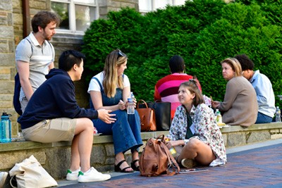 Humanities alumni and faculty chat outside at the Convivium retreat. Humanities alumni and faculty chat outside at the Convivium retreat.