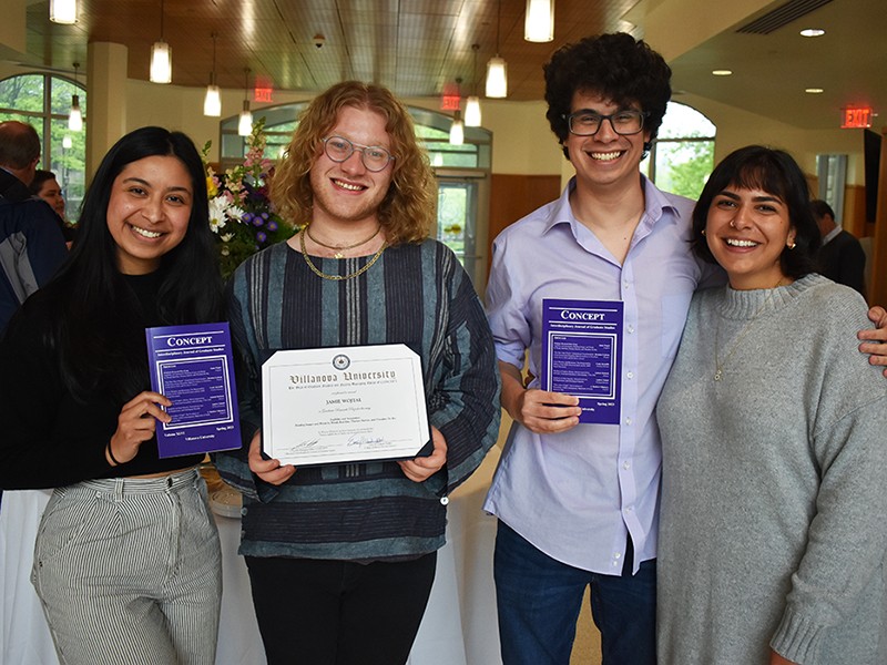 Concept authors pose for a photo with copies of the 2023 edition