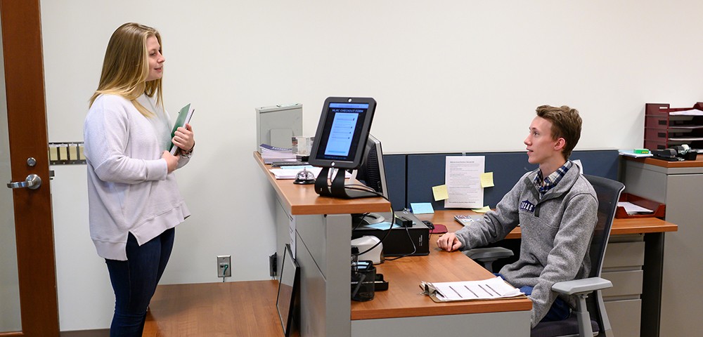 Graduate student checking in at the Math Center