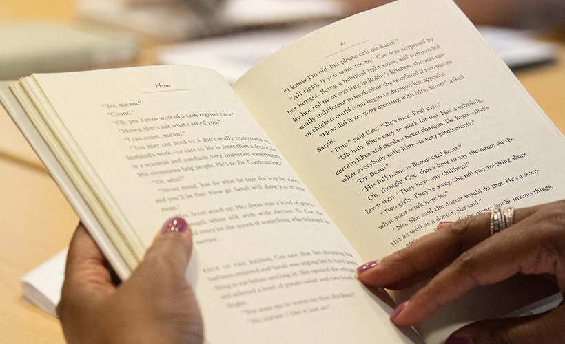 Close up of an individual reading a book.
