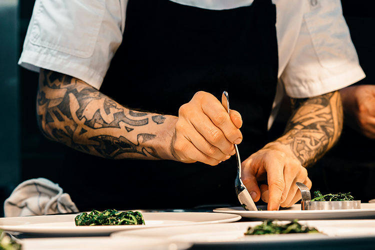 A chef plates a meal.