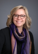 Evelyn Lengetti Female asstitant dean smiling with glasses