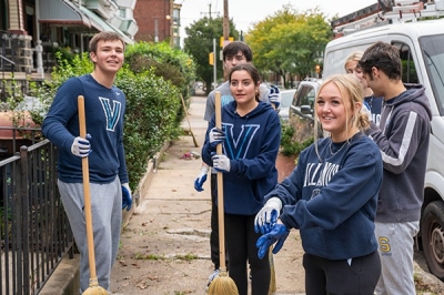 SLLC-service students participating in a neighborhood clean-up service activity