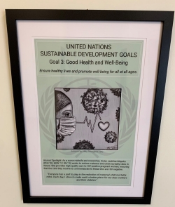 UN SDG poster in Driscoll Hall - Copy Poster with illustration of clinician's face and health care symbols