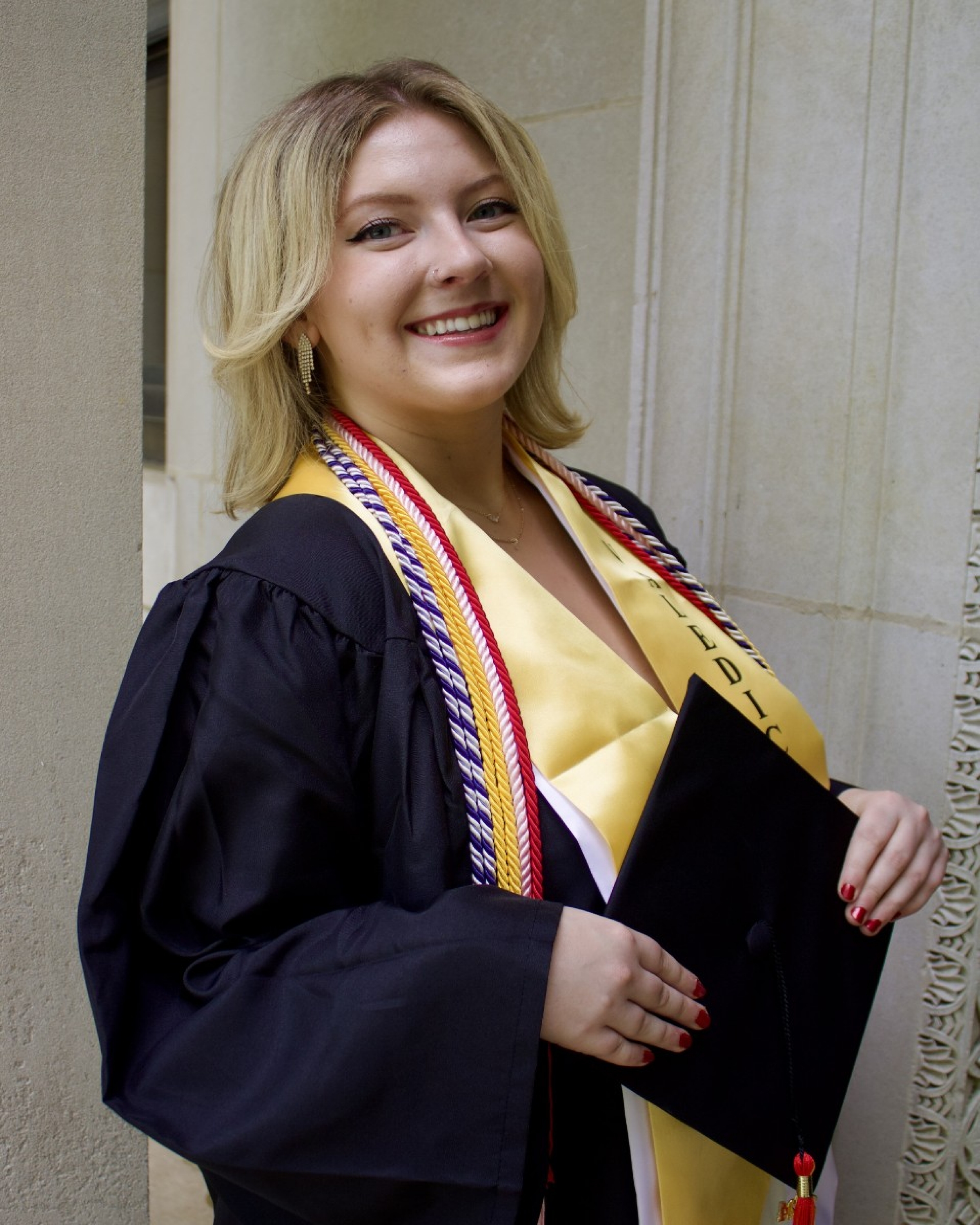 Image of Natalie Rubinkam. Young blond women in graduation robe.