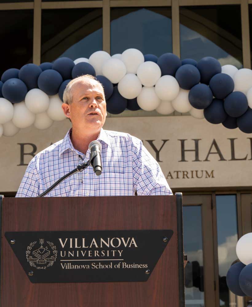 Alumn speaking at a podium