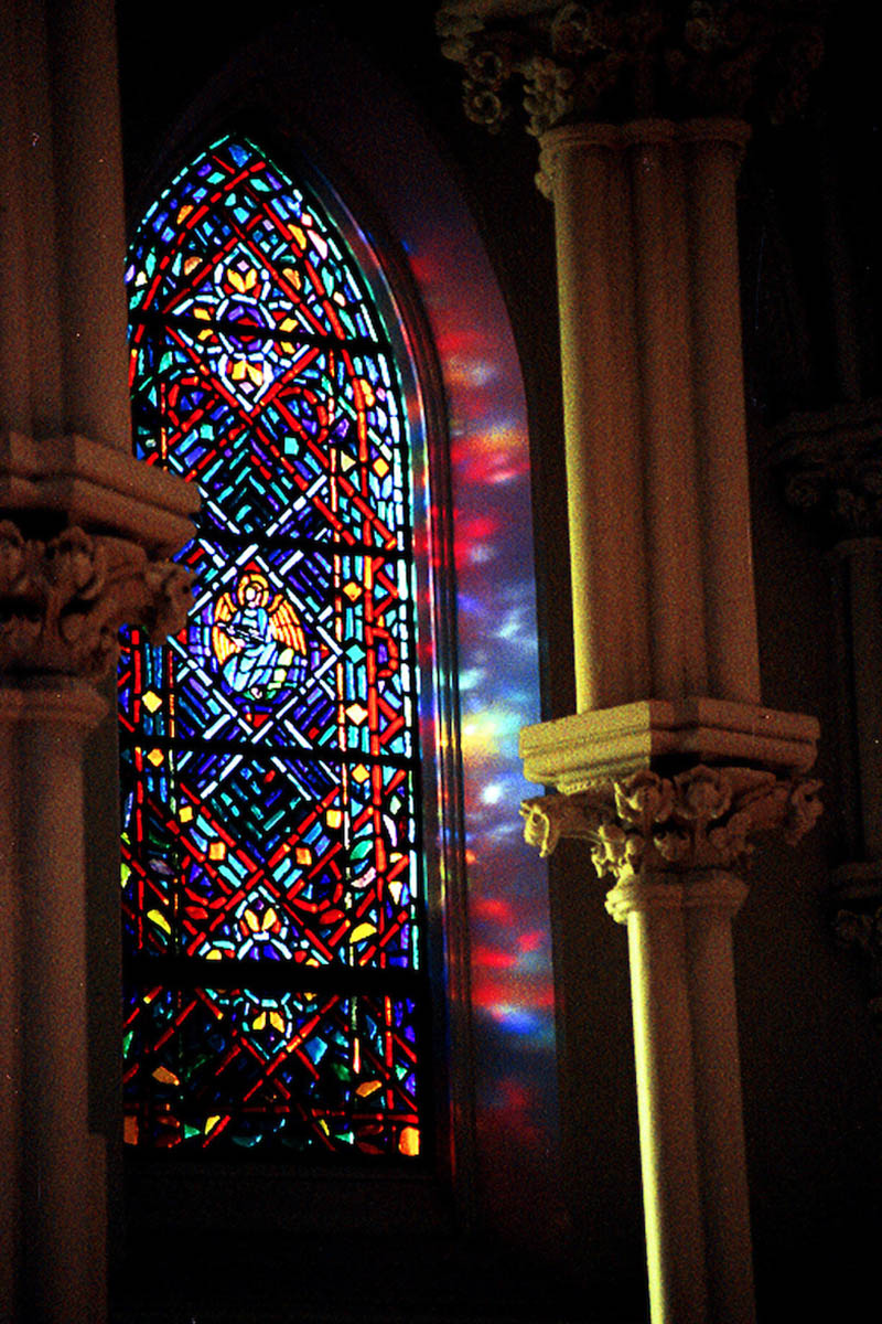 Stained glass in a building next to pillars