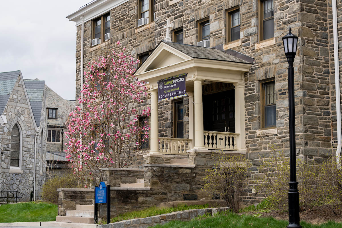 Image of the exterior of St Rita's Hall next to flower beds