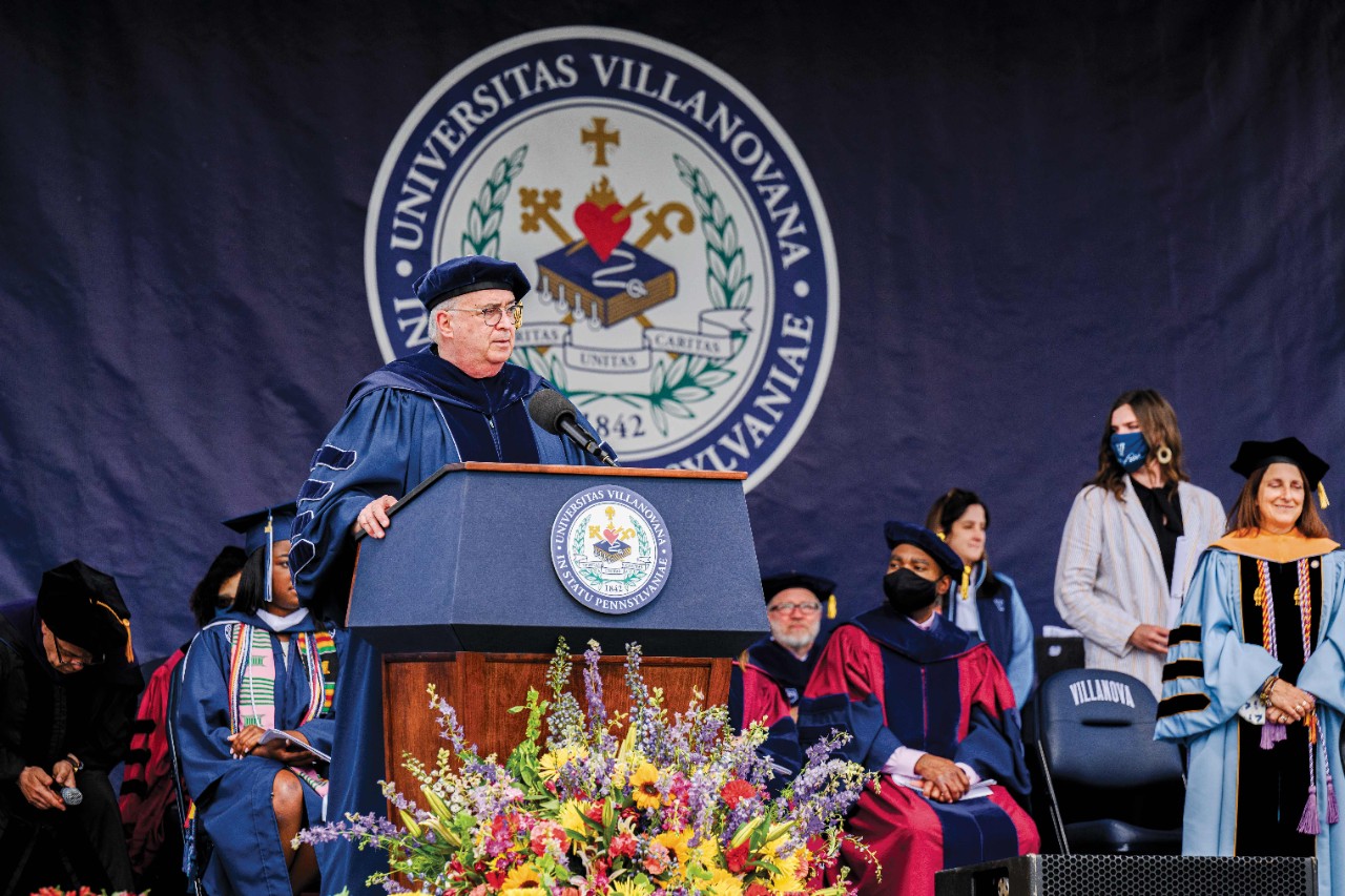 Villanova President Father Peter Donohue speaking from a podium at commencement